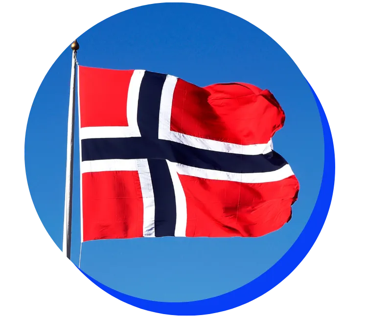 country_norway Norwegian flag flying on a flagpole against a bright blue sky. The flag is red with a blue and white Nordic cross.