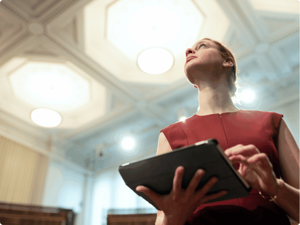 A picture of content moderator analysing new digital threats and thinking of content moderation best practices to avoid them.